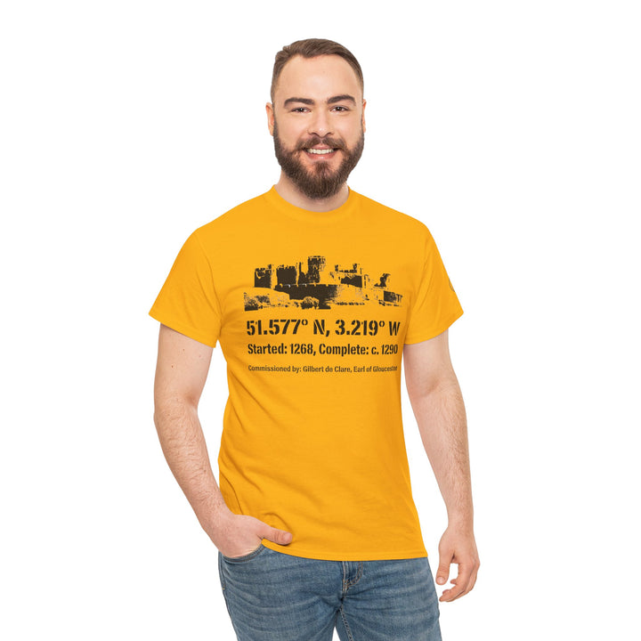 Mustard-yellow Caerphilly Castle T-shirt by S&amp;W Gallus, featuring a castle silhouette graphic with coordinates and historical facts, worn with blue jeans.