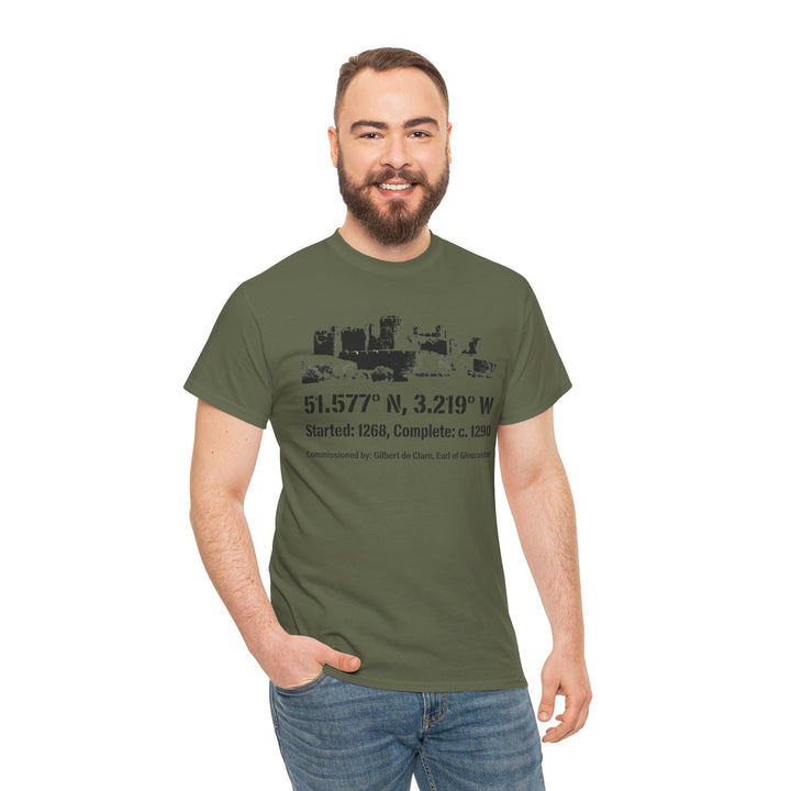 Olive green t-shirt by S&amp;W Gallus with a castle graphic and coordinates, paired with jeans on a smiling man.
