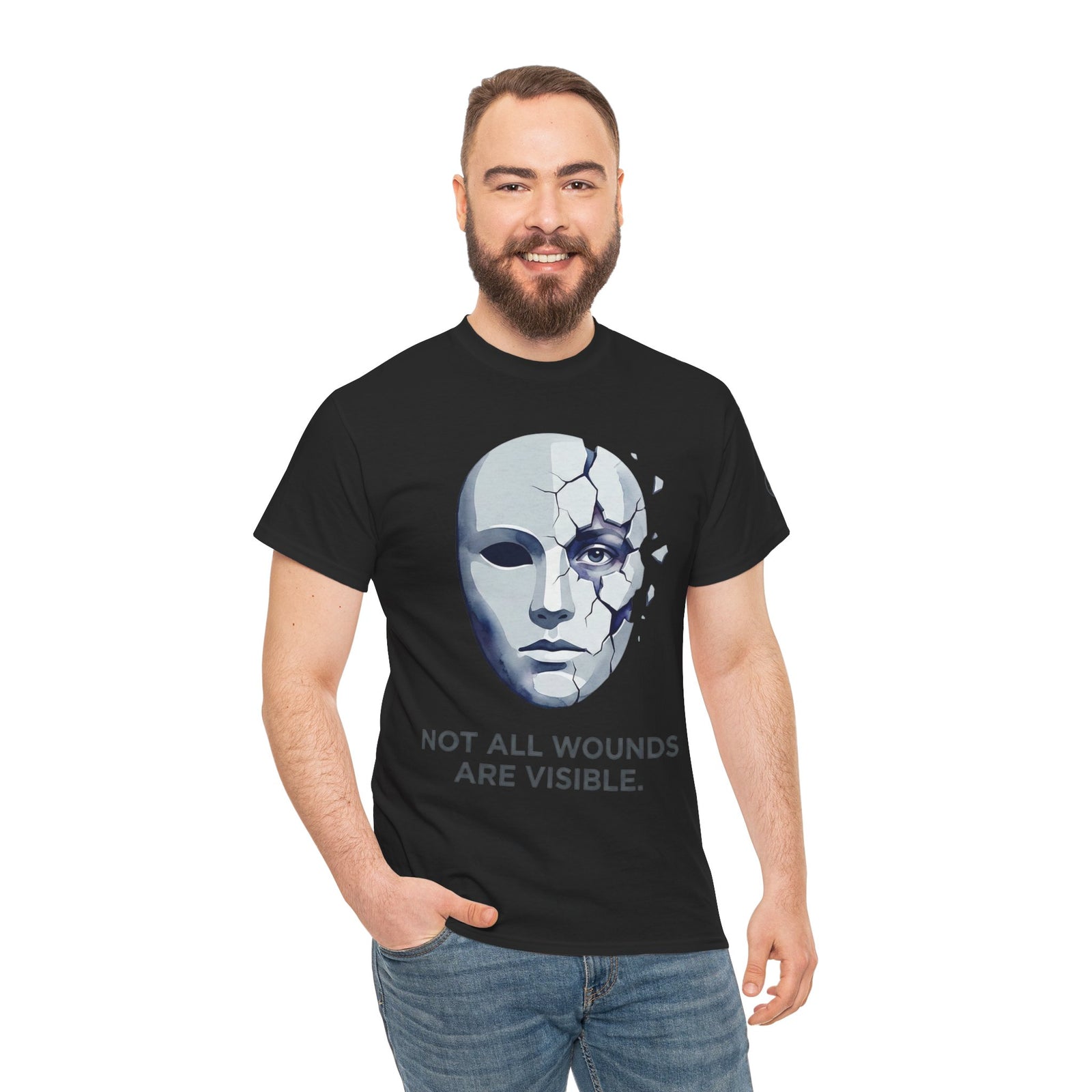 Black T-shirt by Veteran owned, featuring a cracked mask graphic and the phrase "Not All Wounds Are Visible", worn with blue jeans.