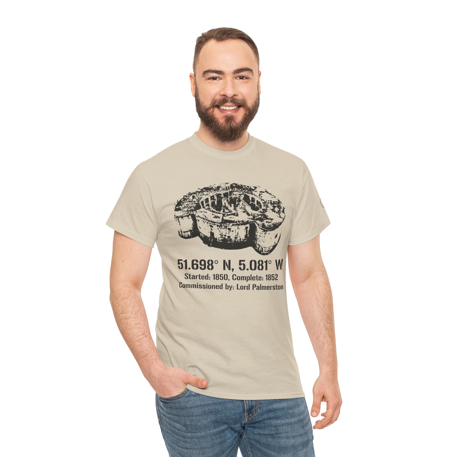 Tan t-shirt with fort graphic by S&W Gallus, worn with jeans by a smiling man.